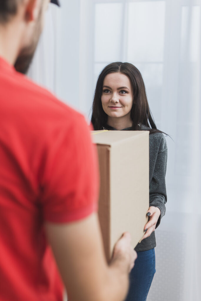 woman receiving parcel with courier (1)